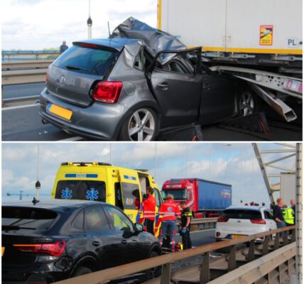 Auto komt onder vrachtwagen trailer terecht op brug in Sleeuwijk