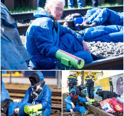 Klimaatactivisten schreeuwen als ze beseffen dat hun handen daadwerkelijk vastzitten op de rails in Rotterdam